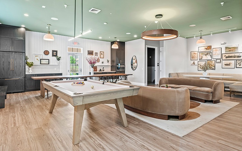 room with a pool table and couch