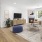Living room with wood floors, modern furniture, and natural lighting