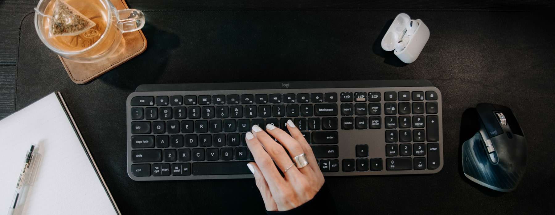 overhead shot of woman typing on keyboard at her desk